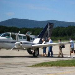 People boarding a small Cape Air plane.