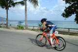 Triathlon athlete riding bicycle by the beach