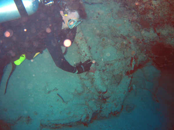 A SCUBA diver with a Ninteenth century anchor on the Cane Bay wall.
