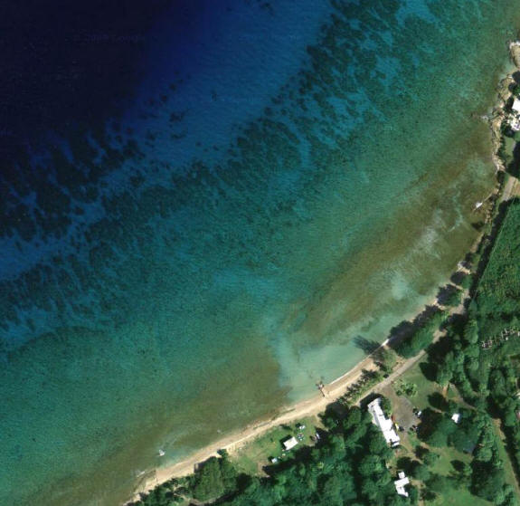 Aerial View of Cane Bay Beach showing the reef under the water.