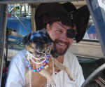 A man dressed as a pirate with his pirate dog at Mardi Croix.