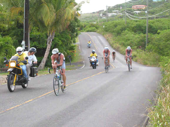 Bicycle riders round a corner in the St. Croix Half Ironman Triathlon.