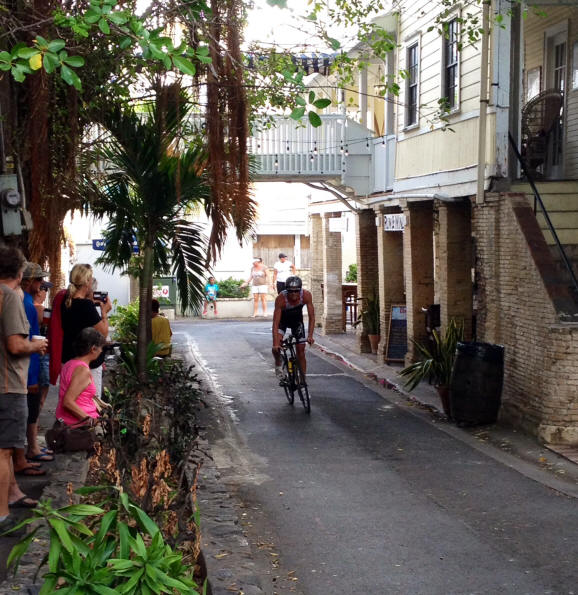 St. Croix Triathlon bicycle rider races through a street in historic Christiansted.